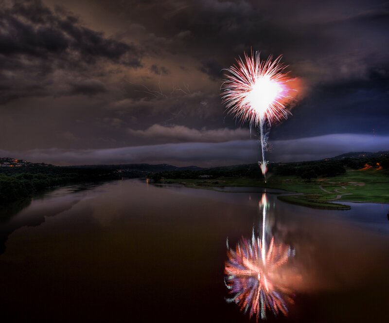 Fireworks over a lake at night