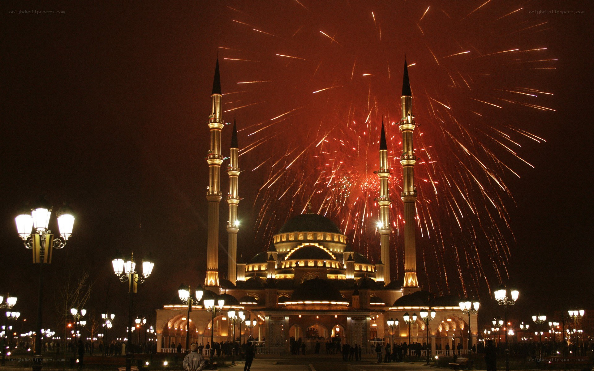 Fireworks over a mosque at night