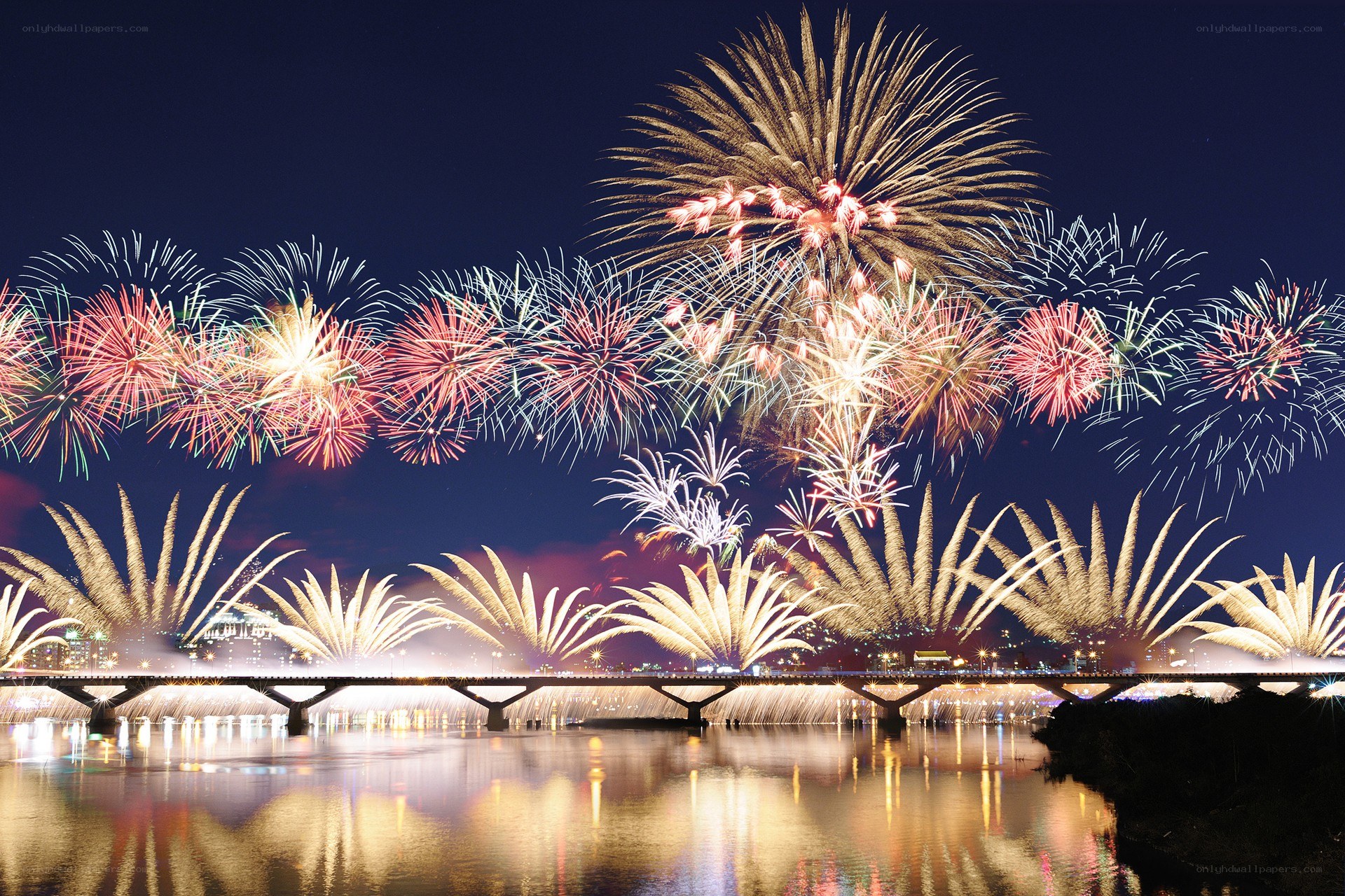 Fireworks over a river at night