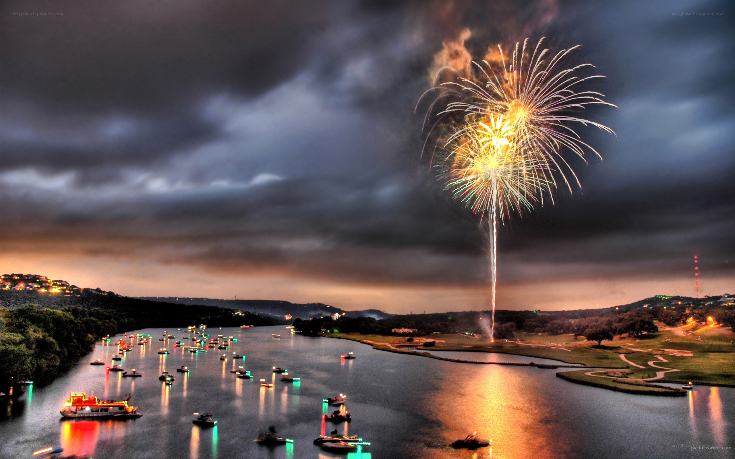 Fireworks over a river at night