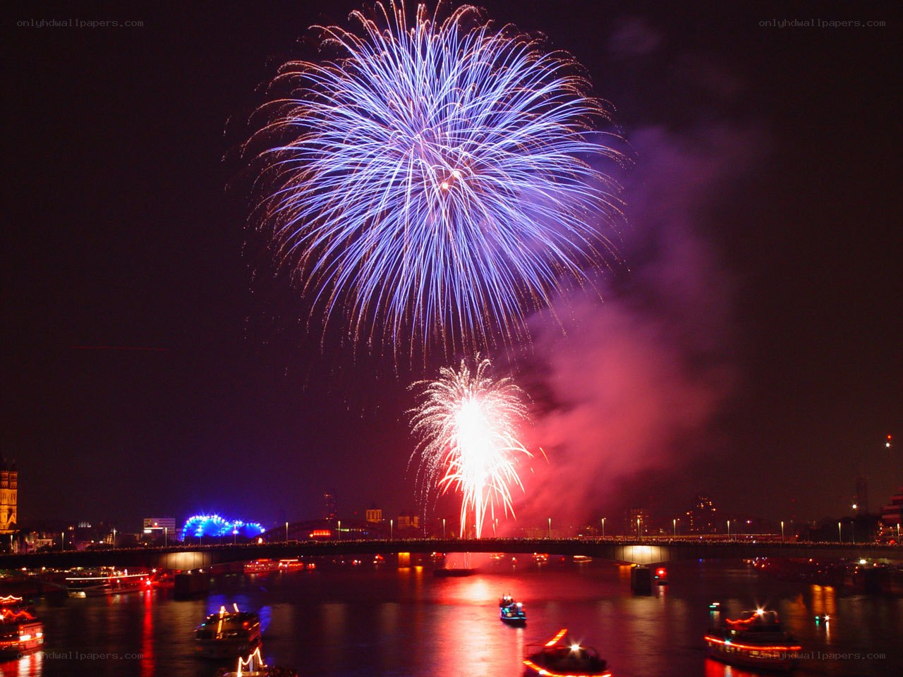 Fireworks over a river at night