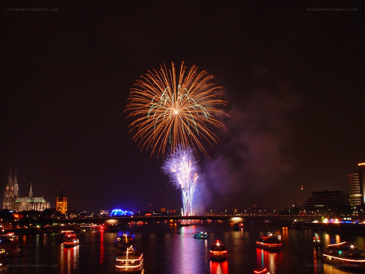 Fireworks over a river at night