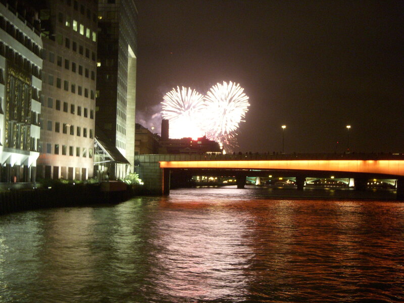 Fireworks over a river at night