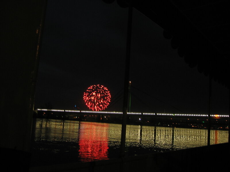 Fireworks over a river at night