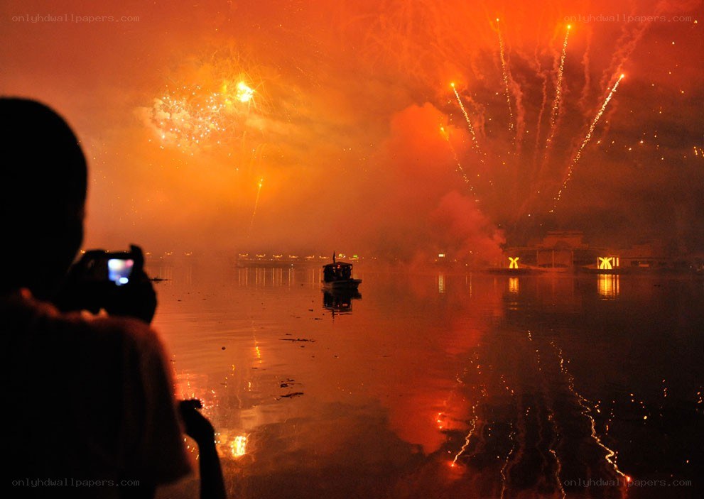 Fireworks over a river at night
