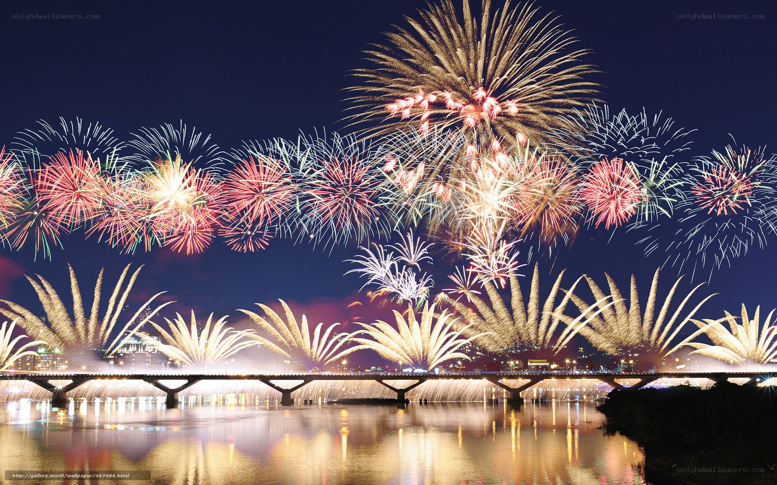 Fireworks over a river bridge