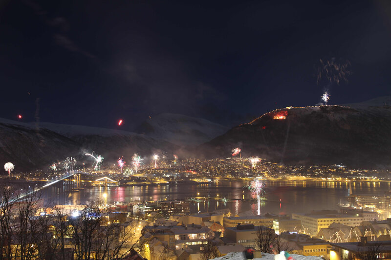 Fireworks over a snowy city