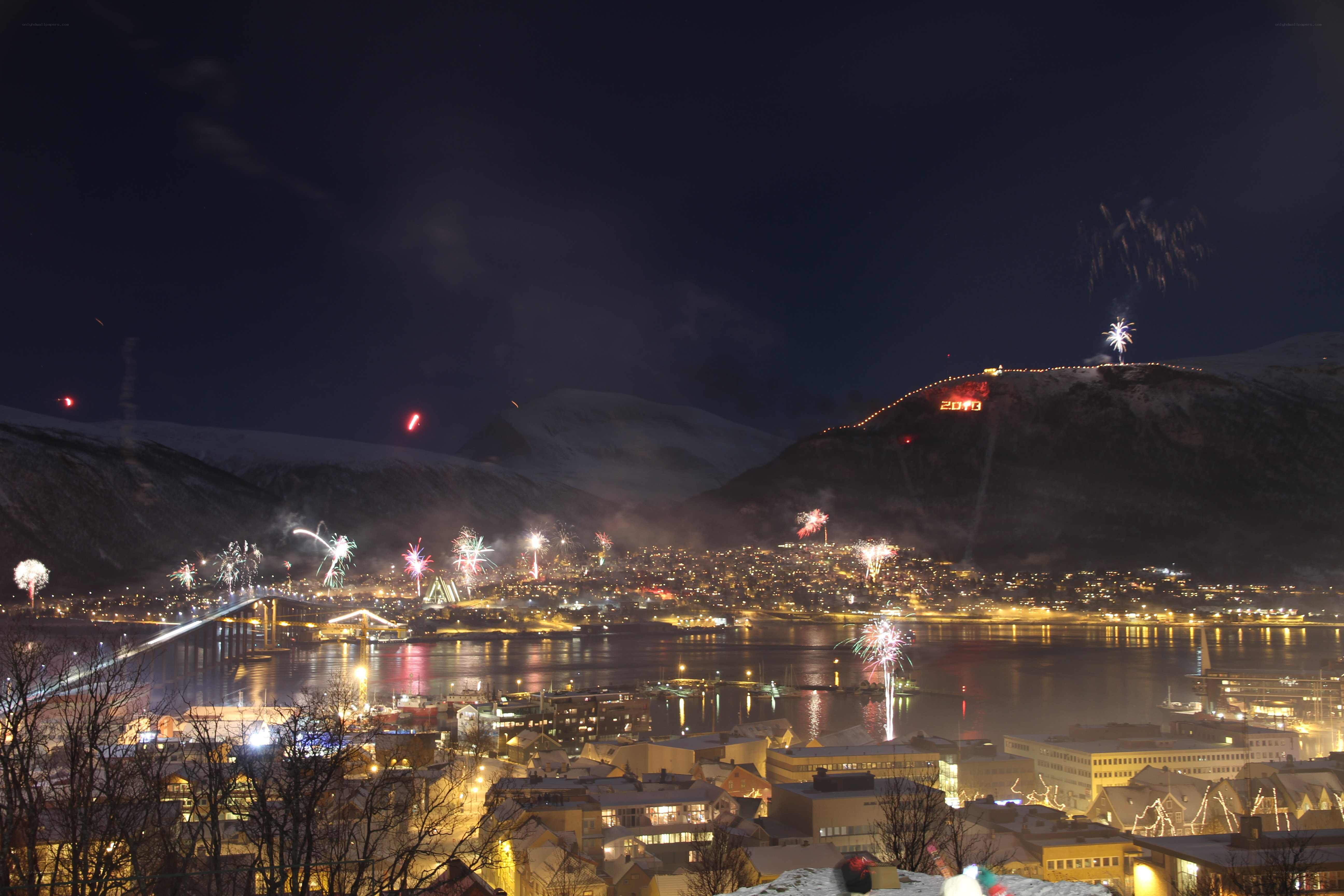 Fireworks over a snowy city