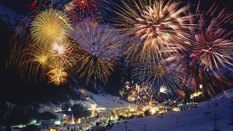 Fireworks over a snowy village