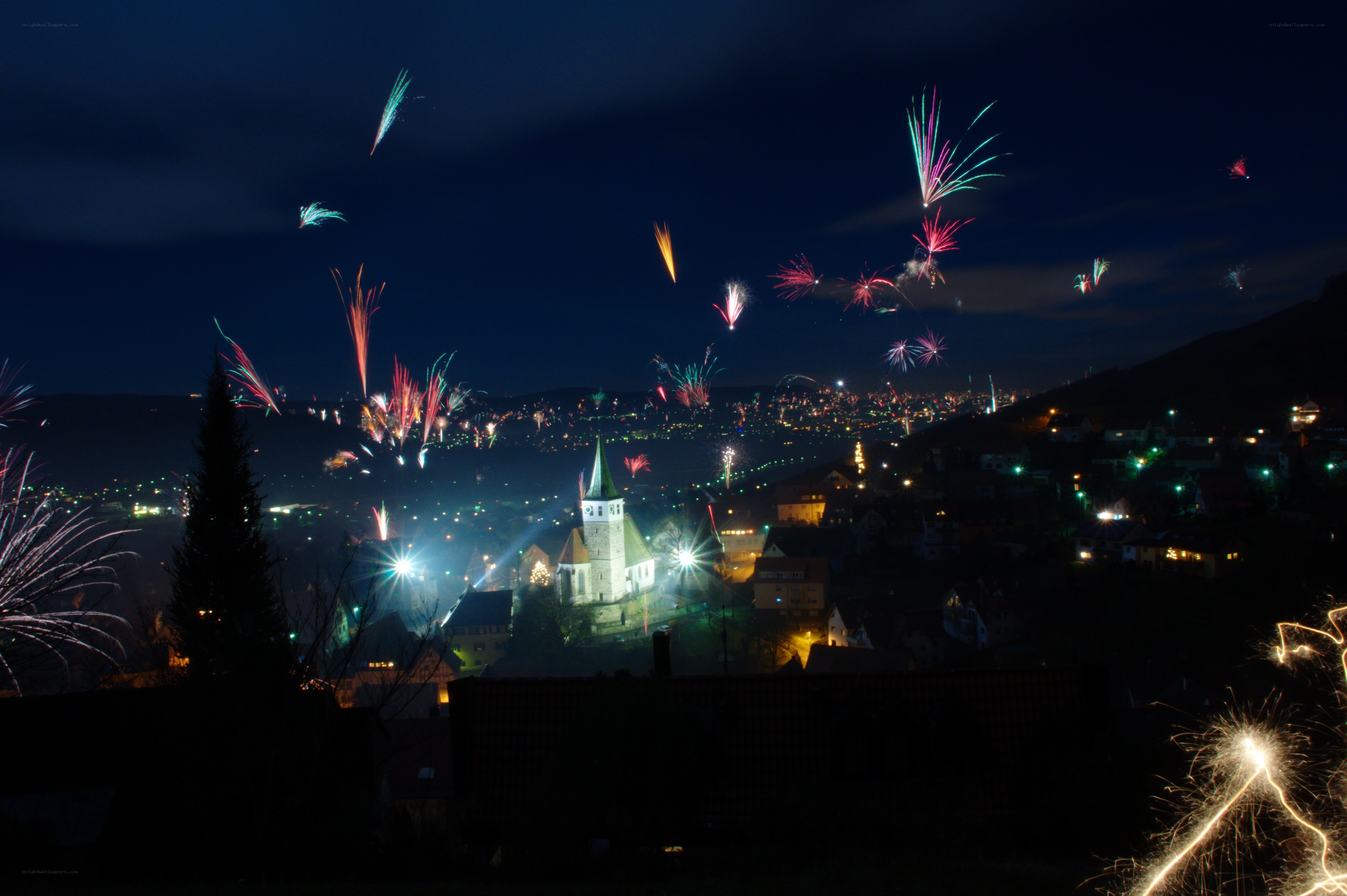 Fireworks over a town at night