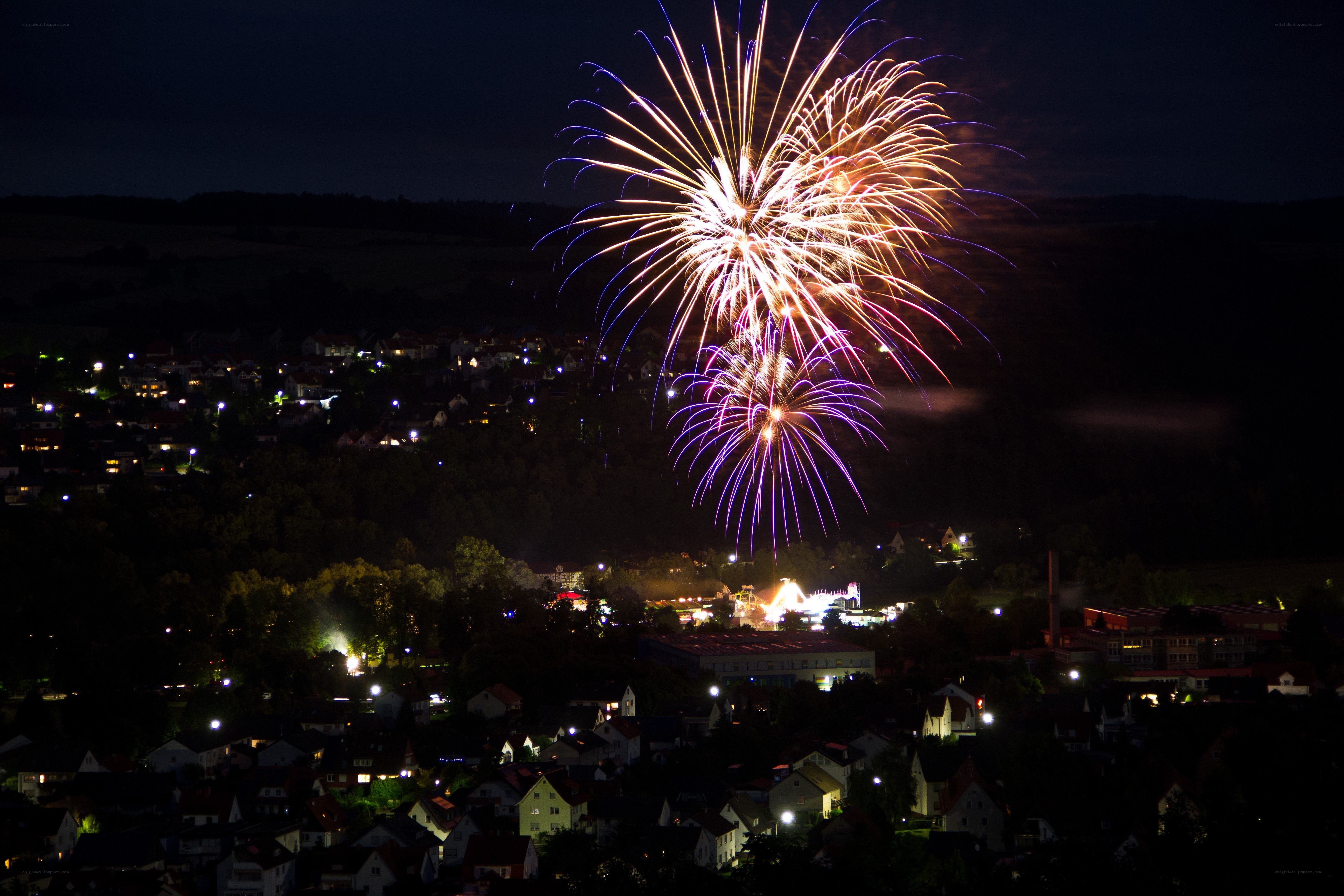 Fireworks over a town at night