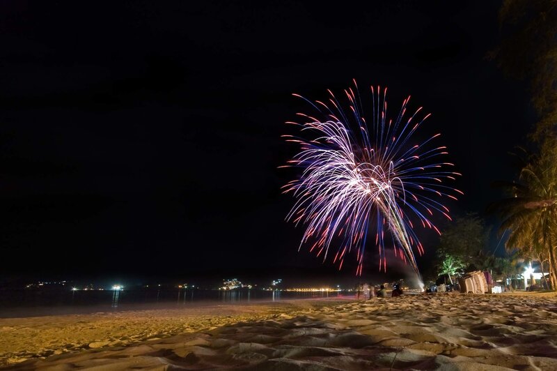 Fireworks over beach at night