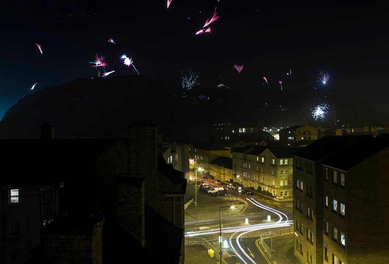 Fireworks over City — Black, Celebratory, Night, Photograph, Buildings, Mountain