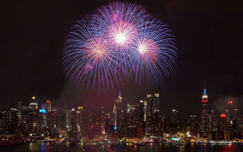 Fireworks over City — Blue, Celebratory, Night, Photograph, Skyscraper, River, Buildings