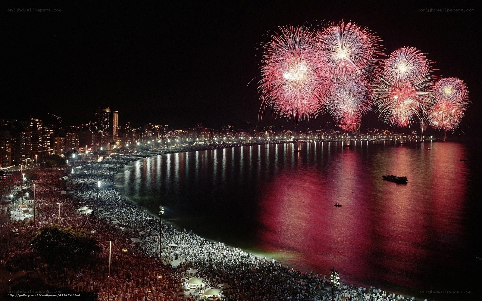 Fireworks over crowded beach