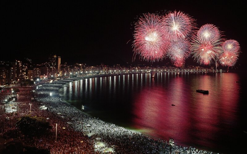 Fireworks over crowded beach