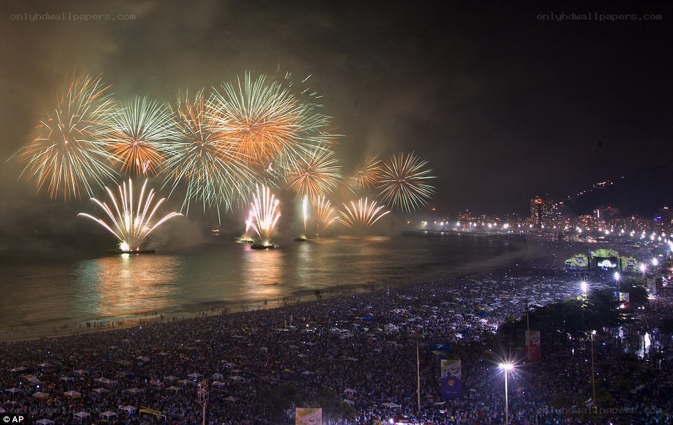 Fireworks over crowded beach