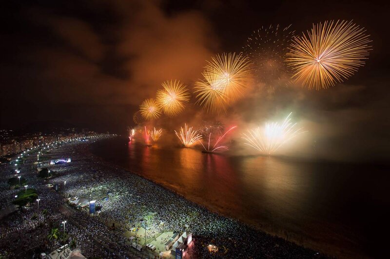 Fireworks over crowded beach