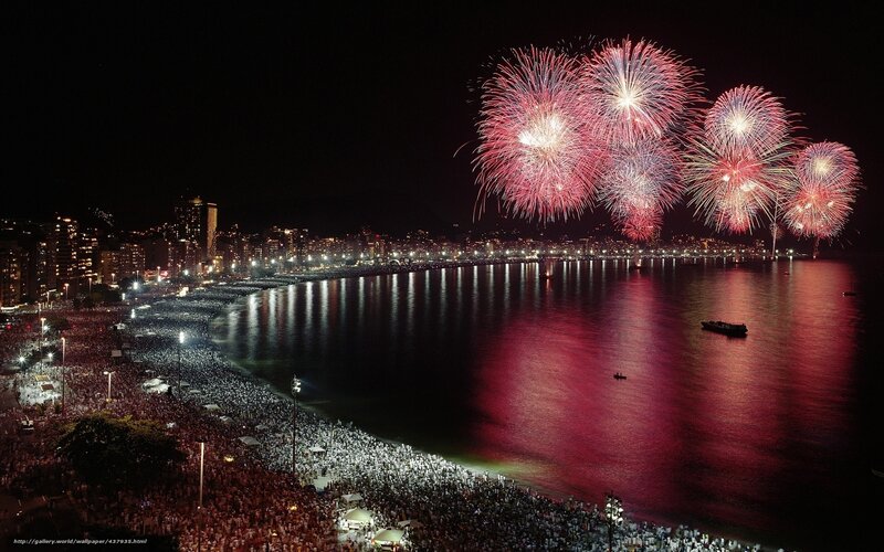 Fireworks over crowded beach