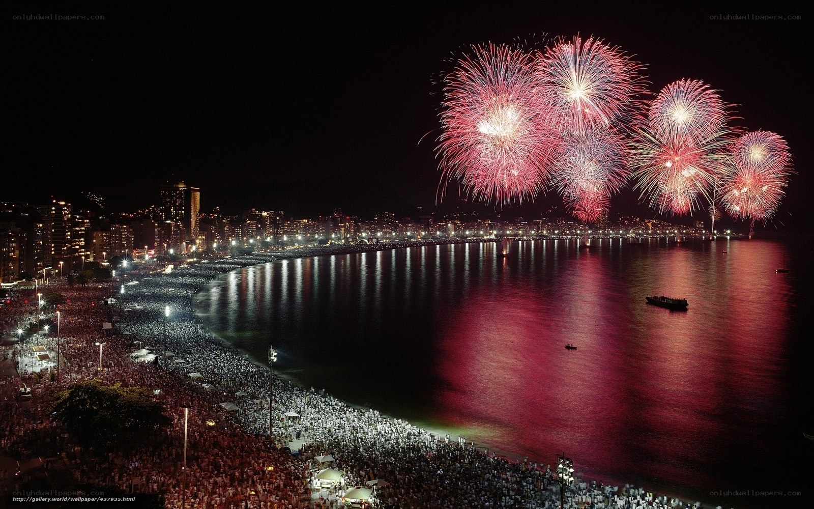 Fireworks over crowded beach
