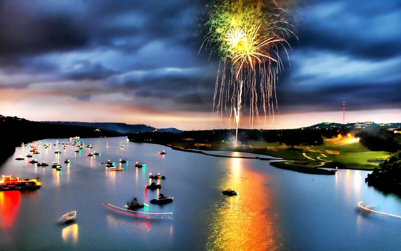 Fireworks over lake at dusk