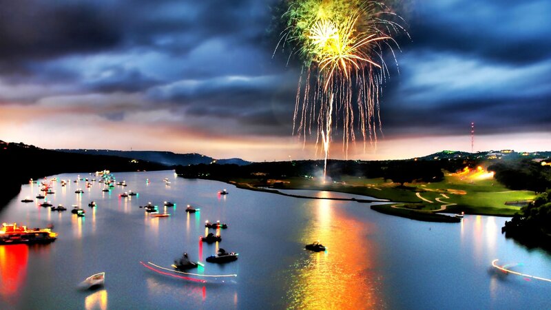 Fireworks over lake with boats