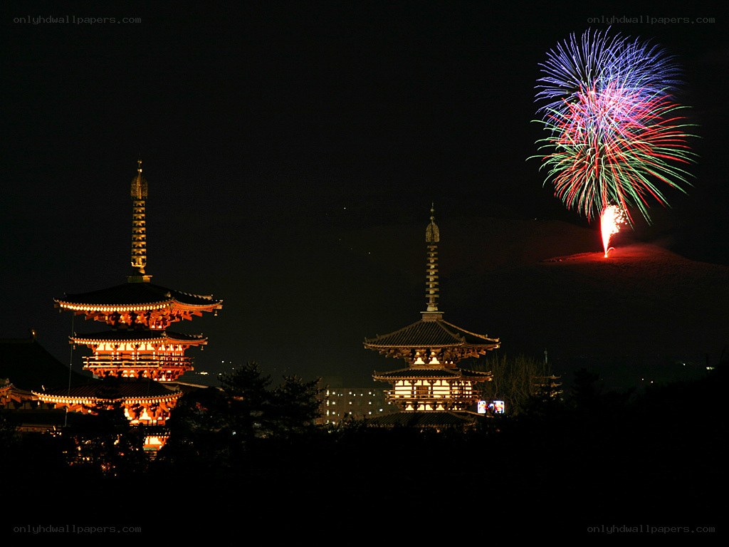 Fireworks over pagodas at night