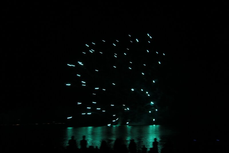 Fireworks over water at night