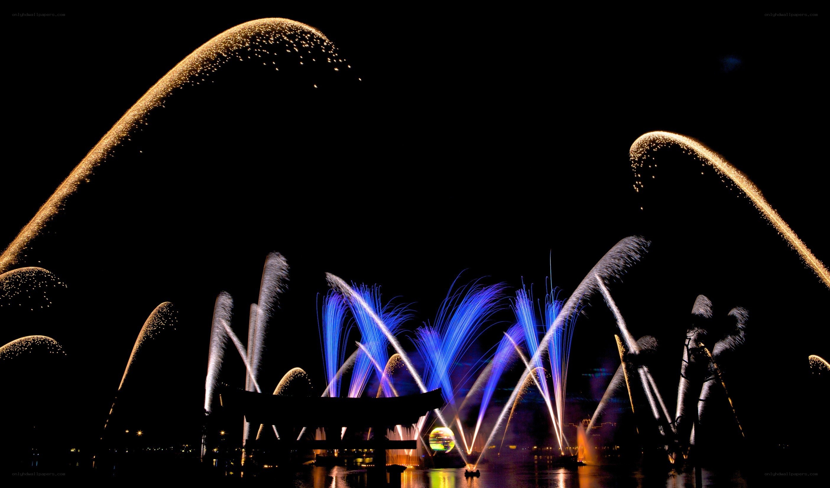 Fireworks over water at night