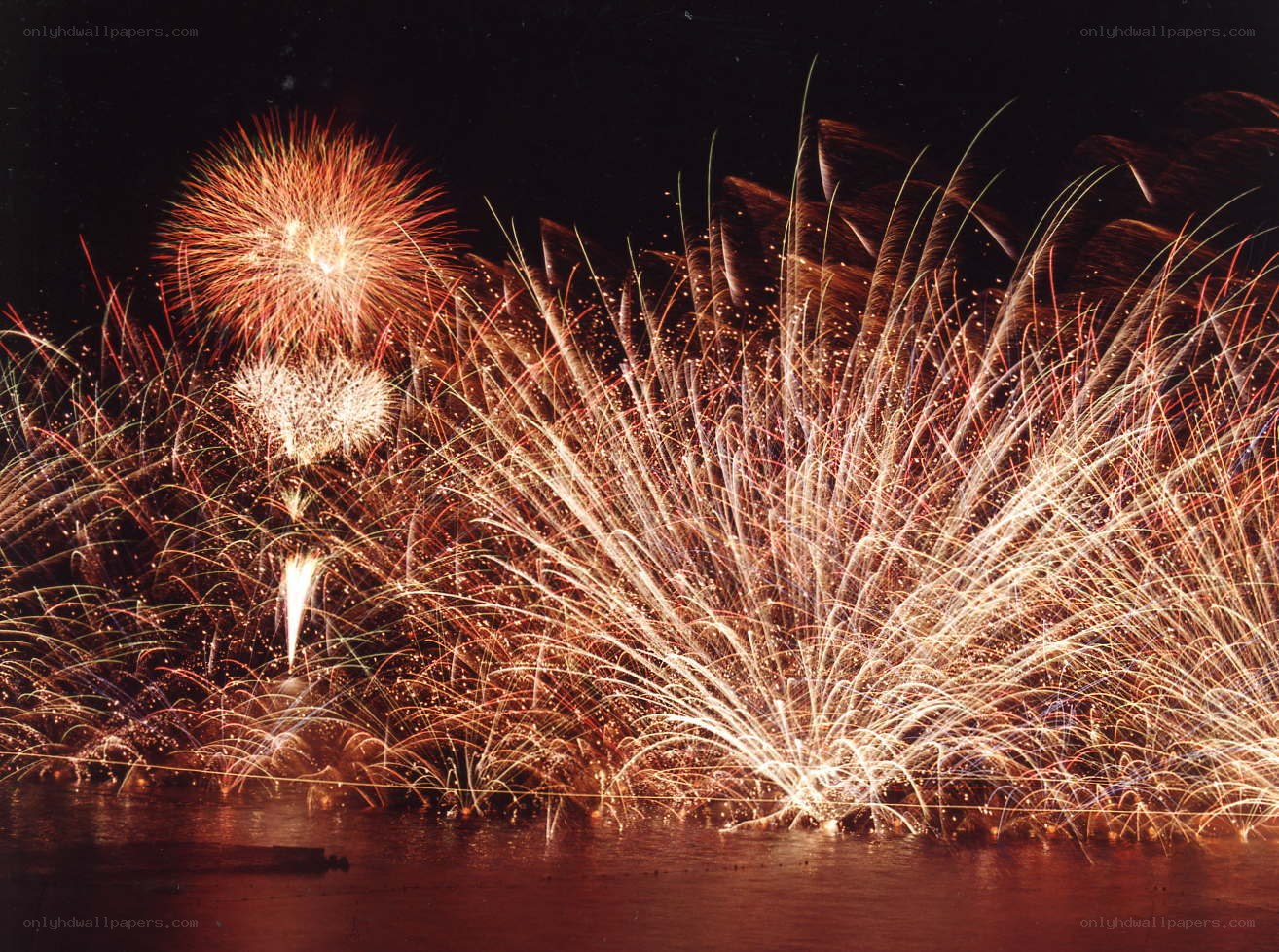 Fireworks over water at night