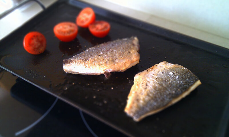 Fish fillets cooking on a griddle