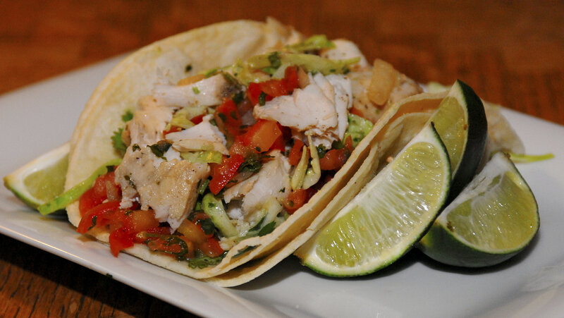Fish tacos with lime wedges