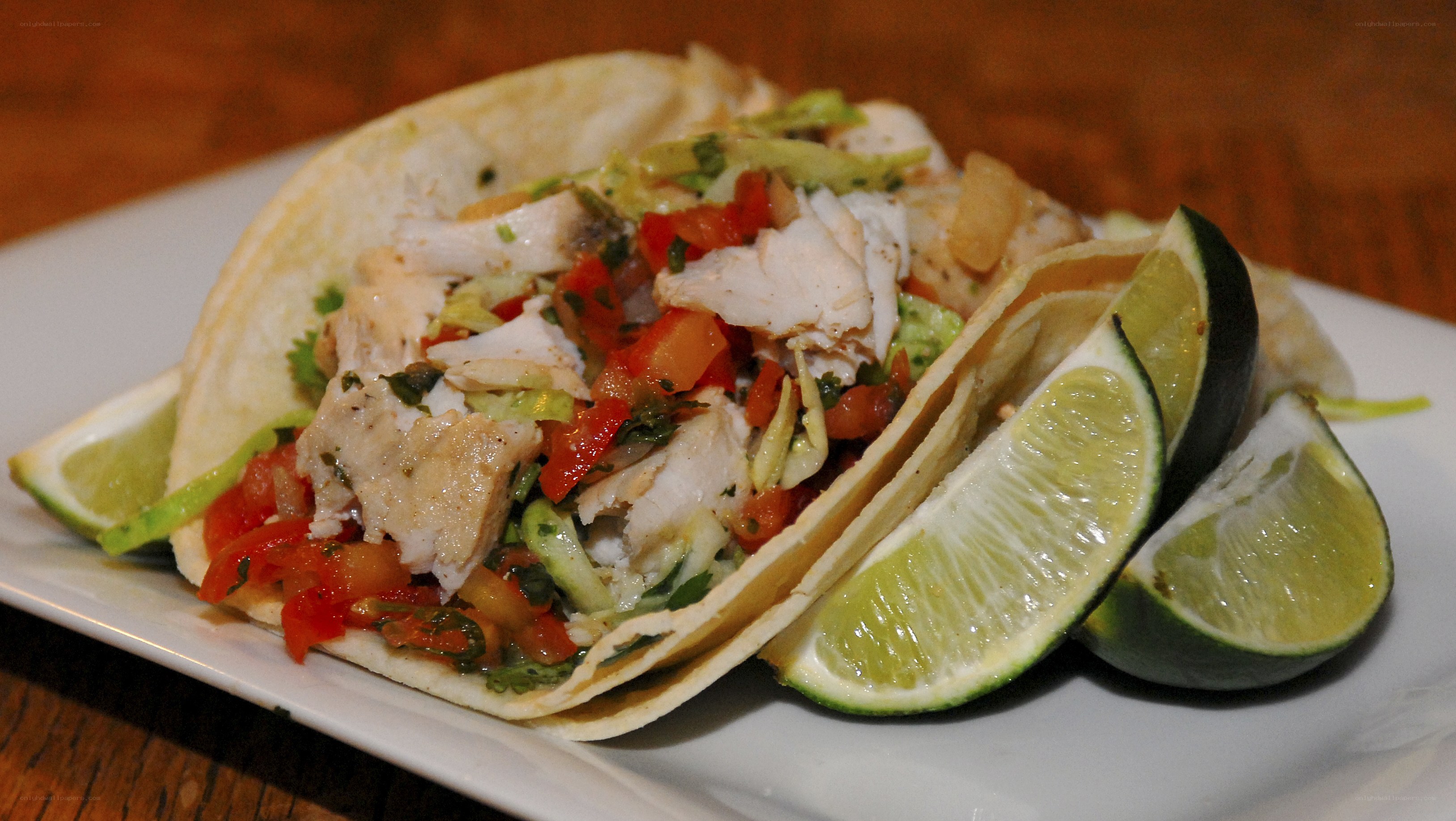 Fish tacos with lime wedges
