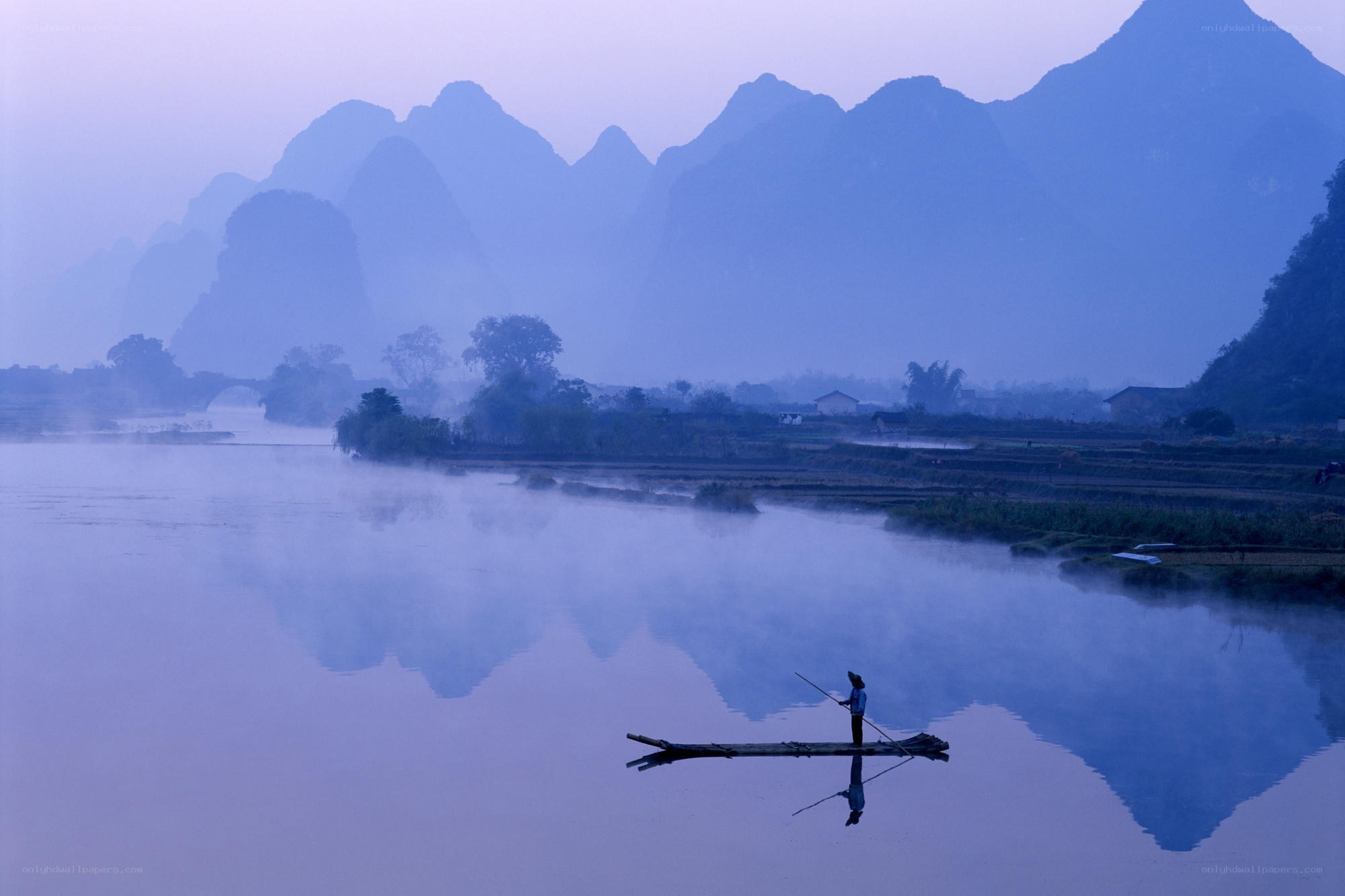Fisher on a misty river
