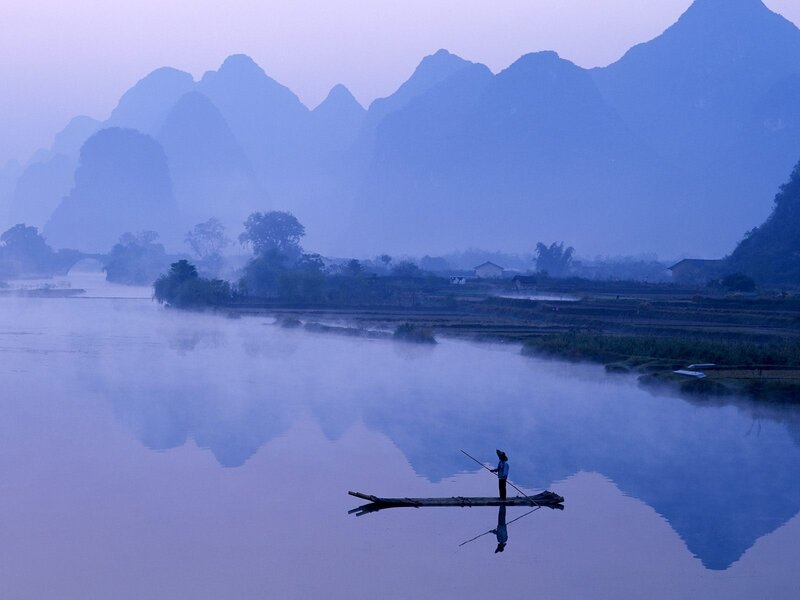 Fisher on a misty river
