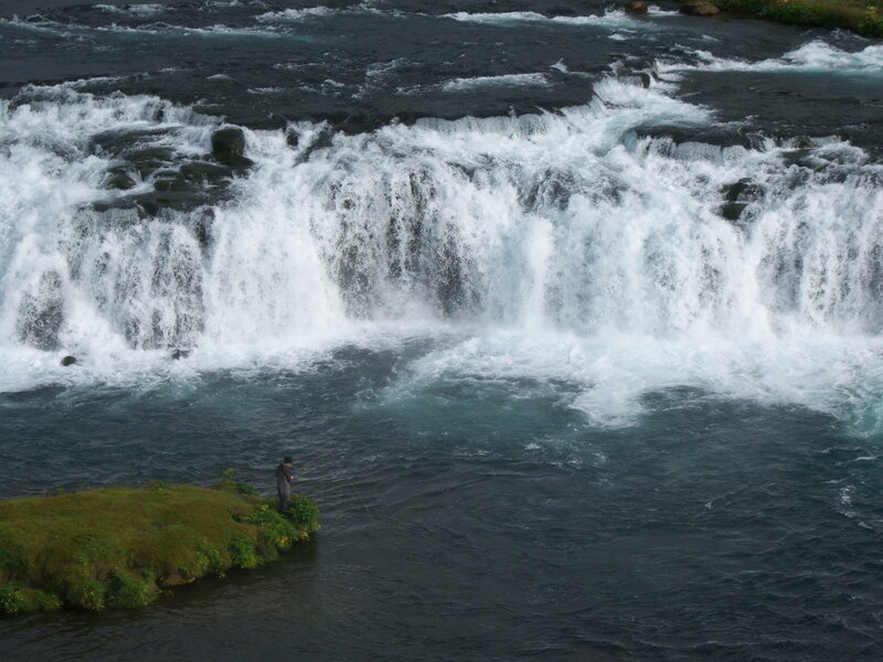 Fisherman at a waterfall
