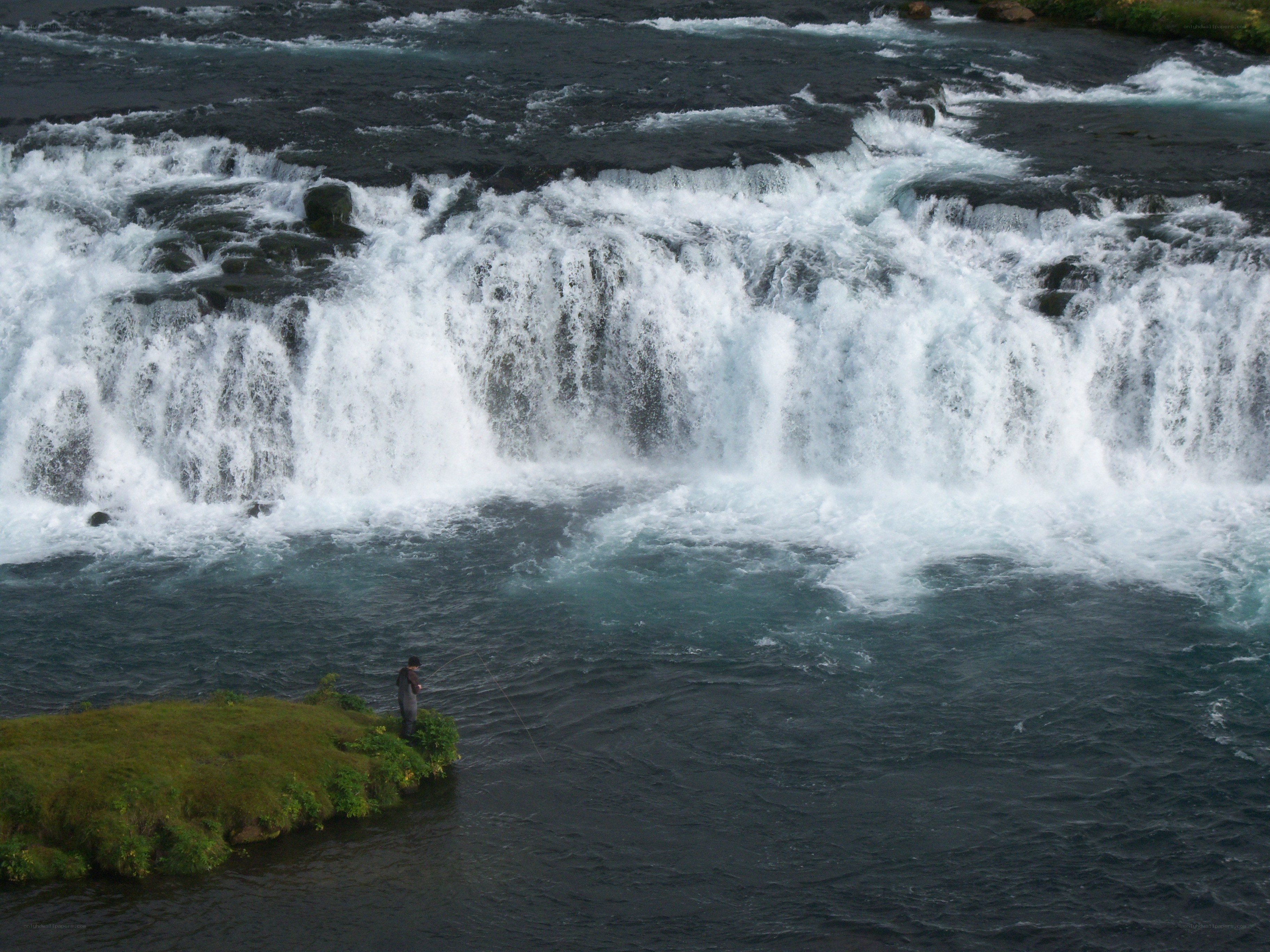 Fisherman at a waterfall