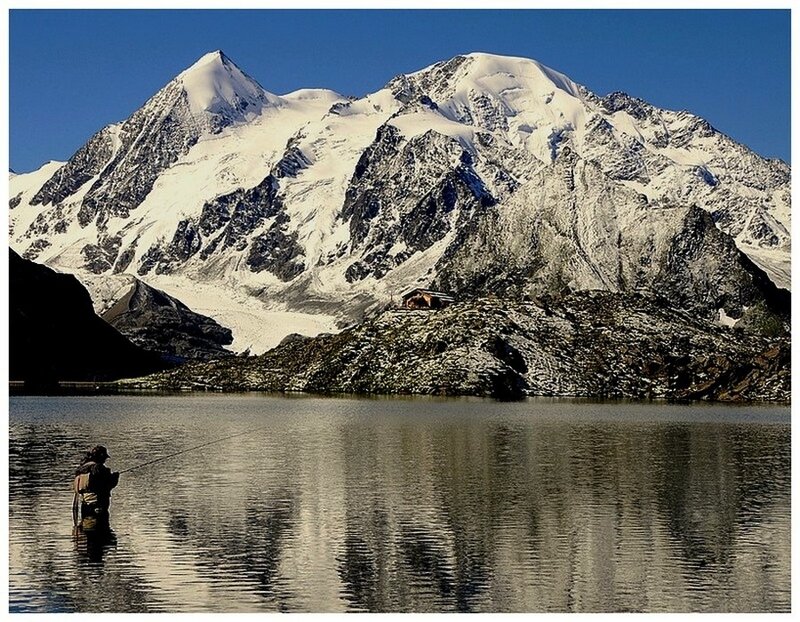 Fisherman at alpine lake