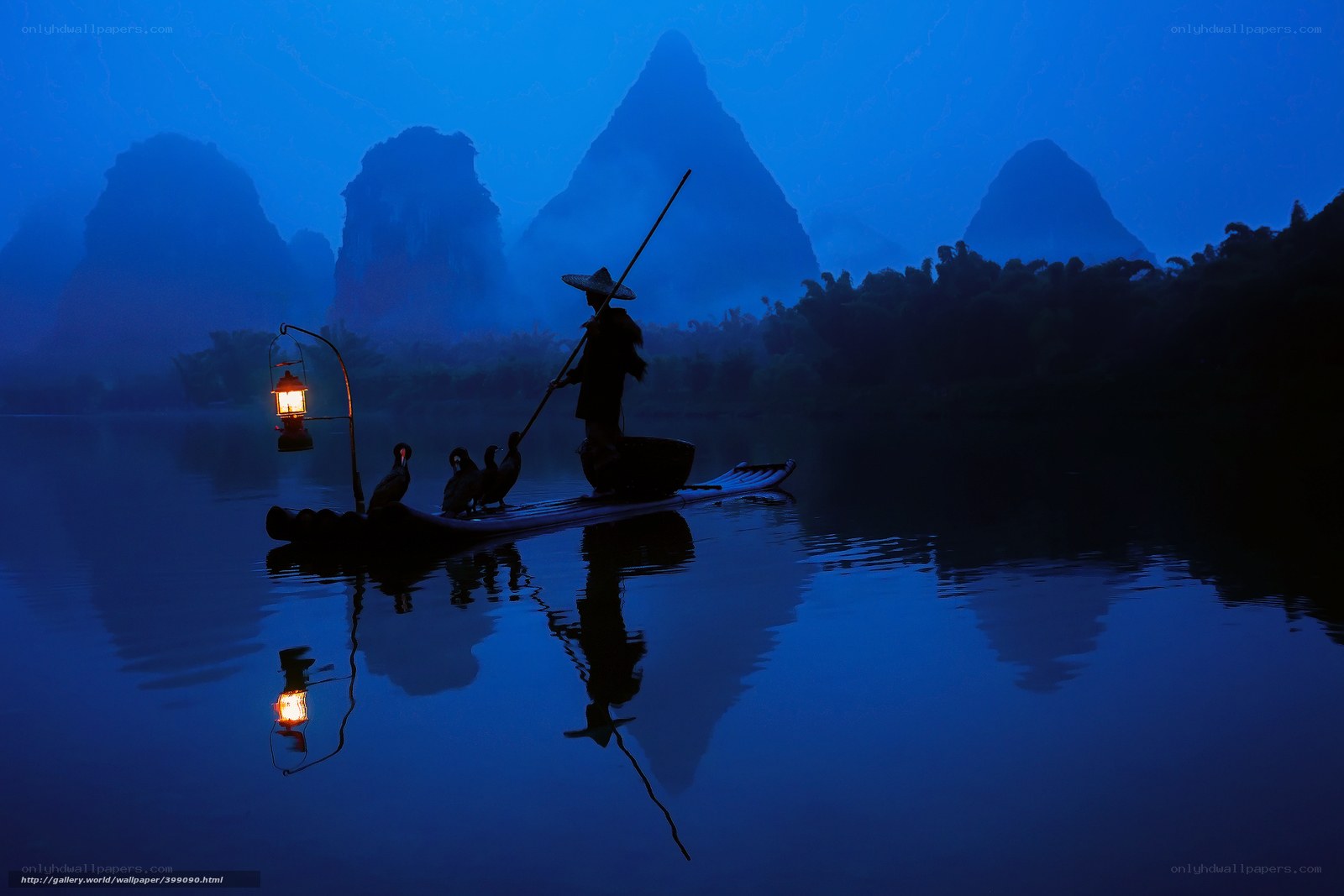 Fisherman at dawn on a misty river