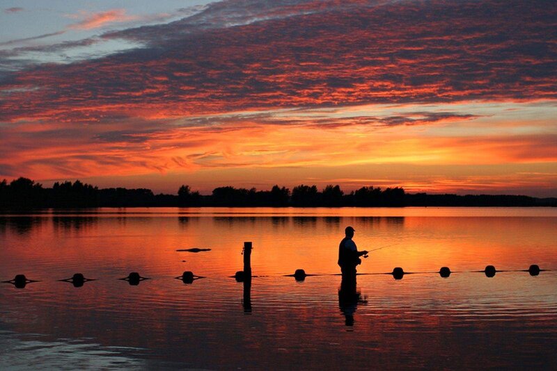 Fisherman at sunset on a lake