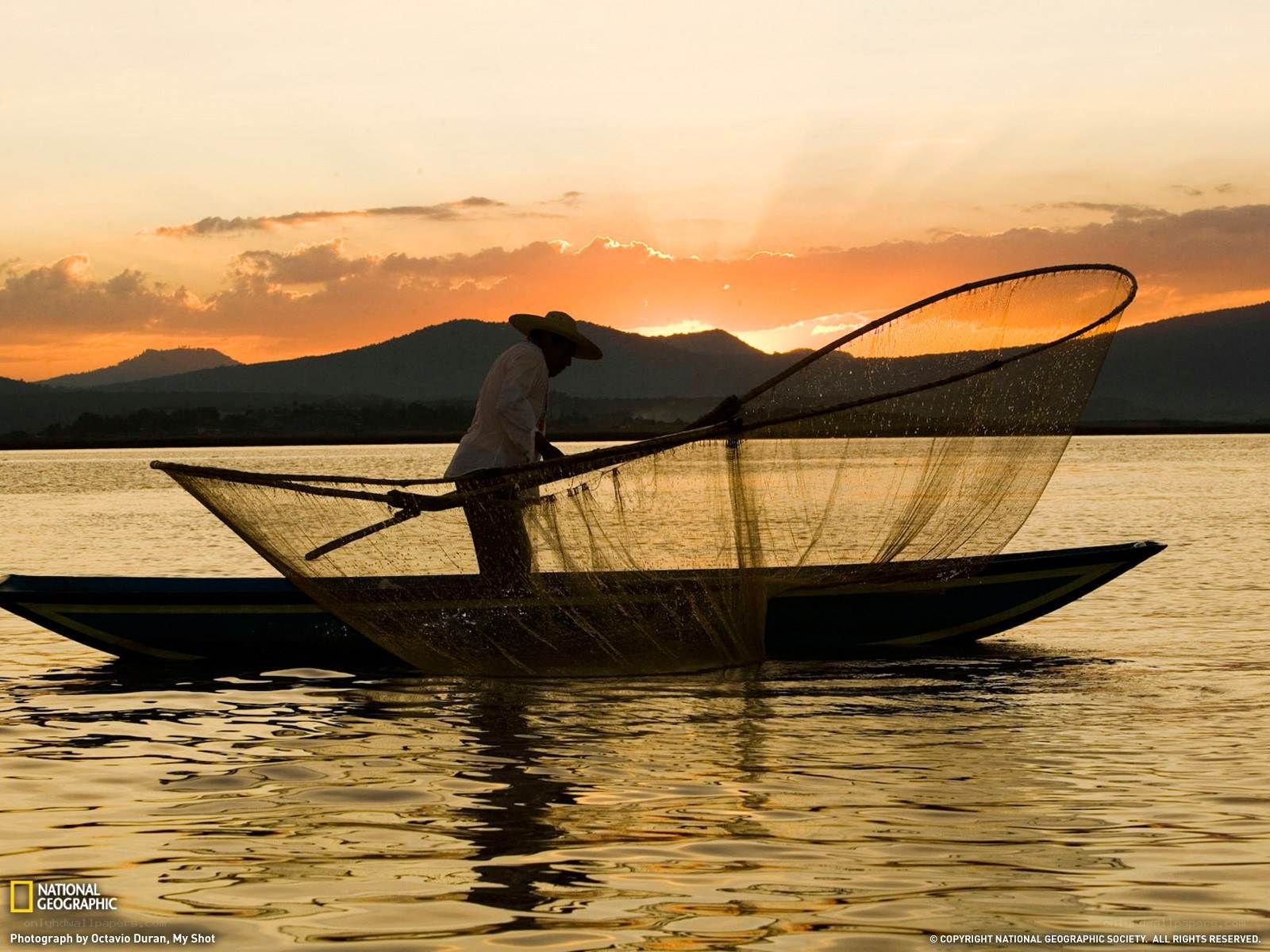 Fisherman at sunset on a lake