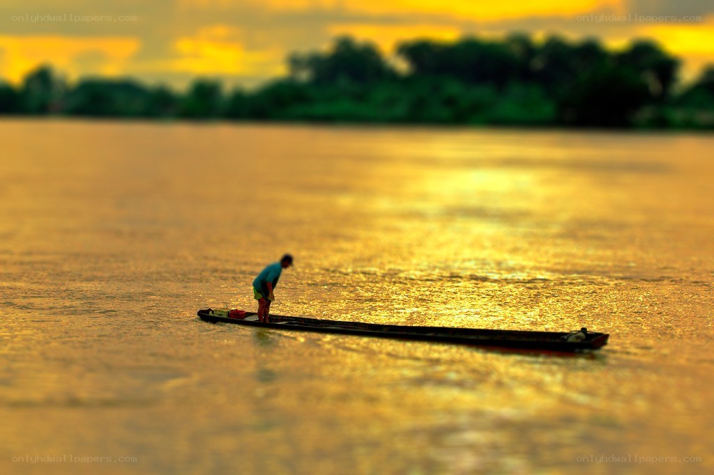 Fisherman at sunset on a river