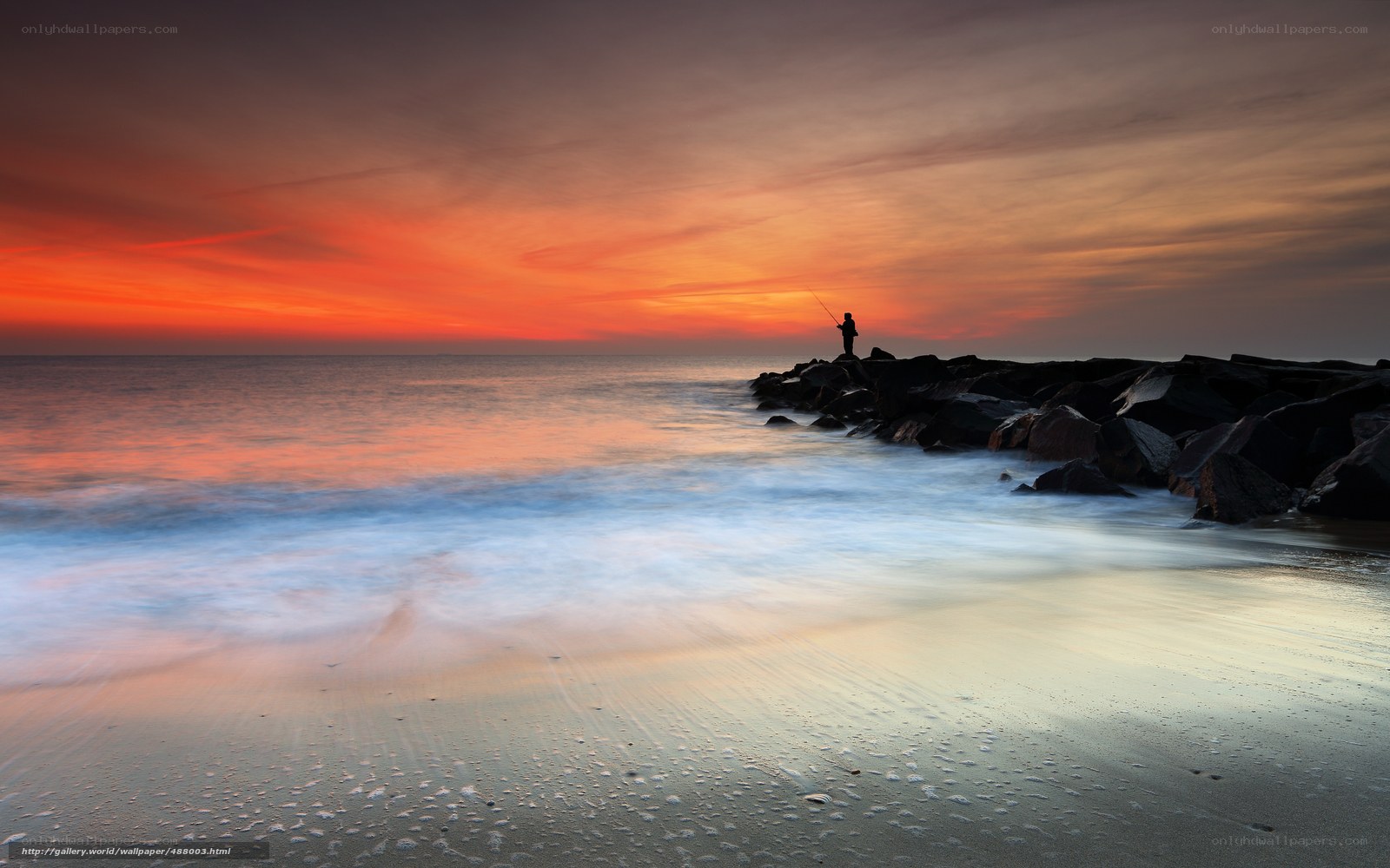 Fisherman at sunset on the beach