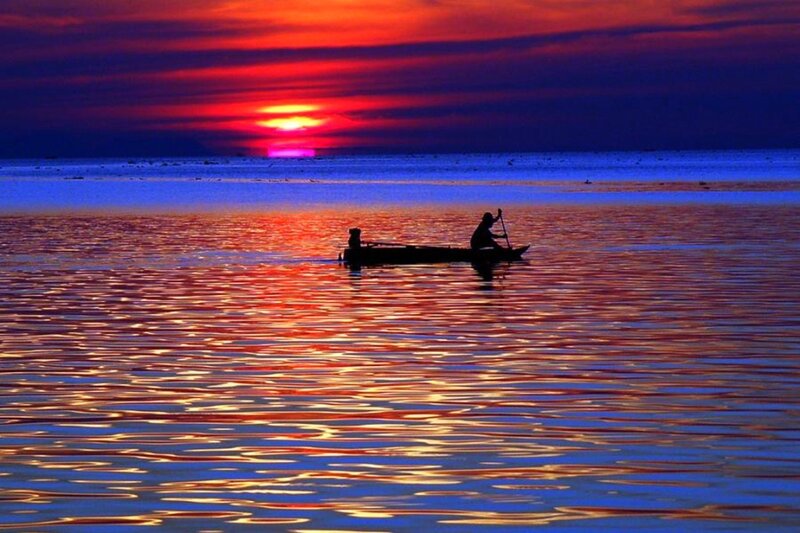 Fisherman at sunset on the water
