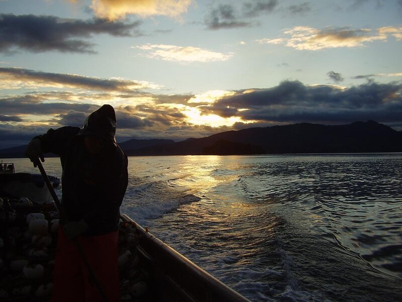 Fisherman at sunset on the water