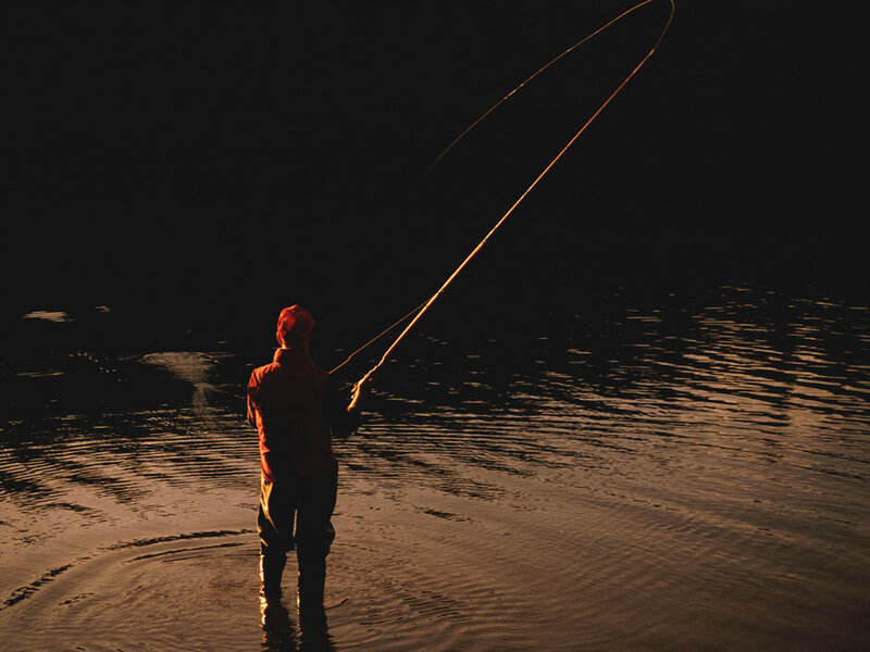 fisherman casting at dusk