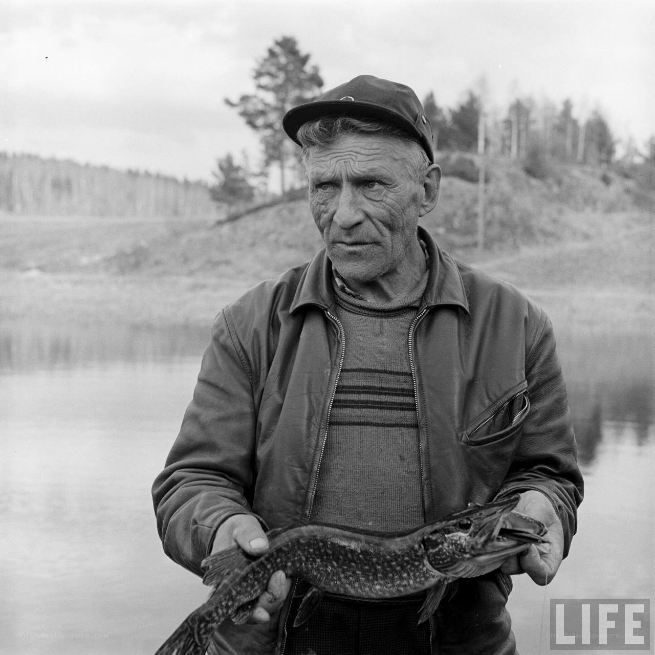 Fisherman holding pike