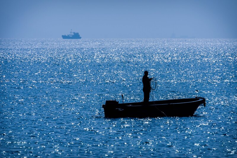 Fisherman in a Boat — Blue, Serene, Afternoon