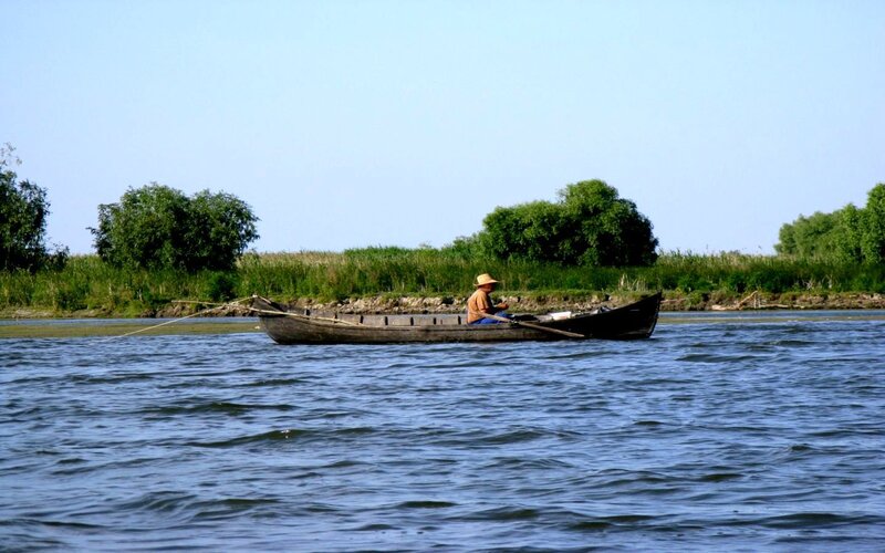 Fisherman in a boat on the river