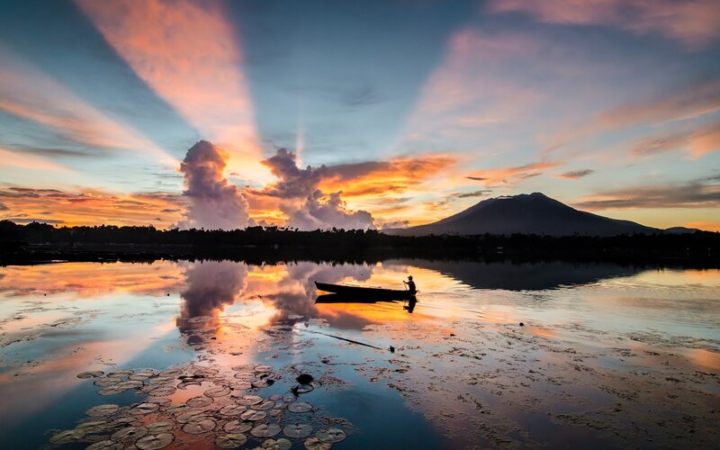 Fisherman in a Boat — Orange, Serene, Sunset, Photograph, Mountain